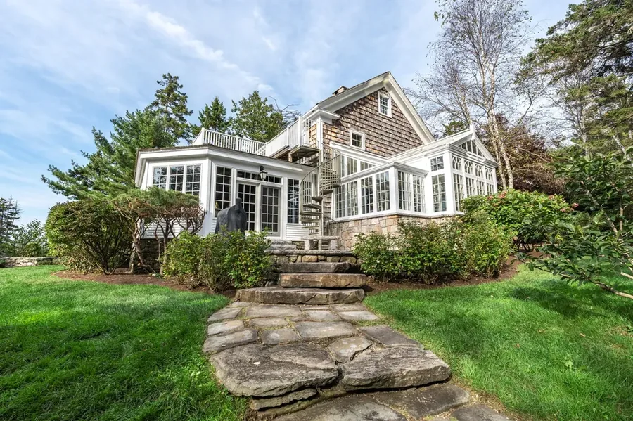 Shingle-style home with stone path